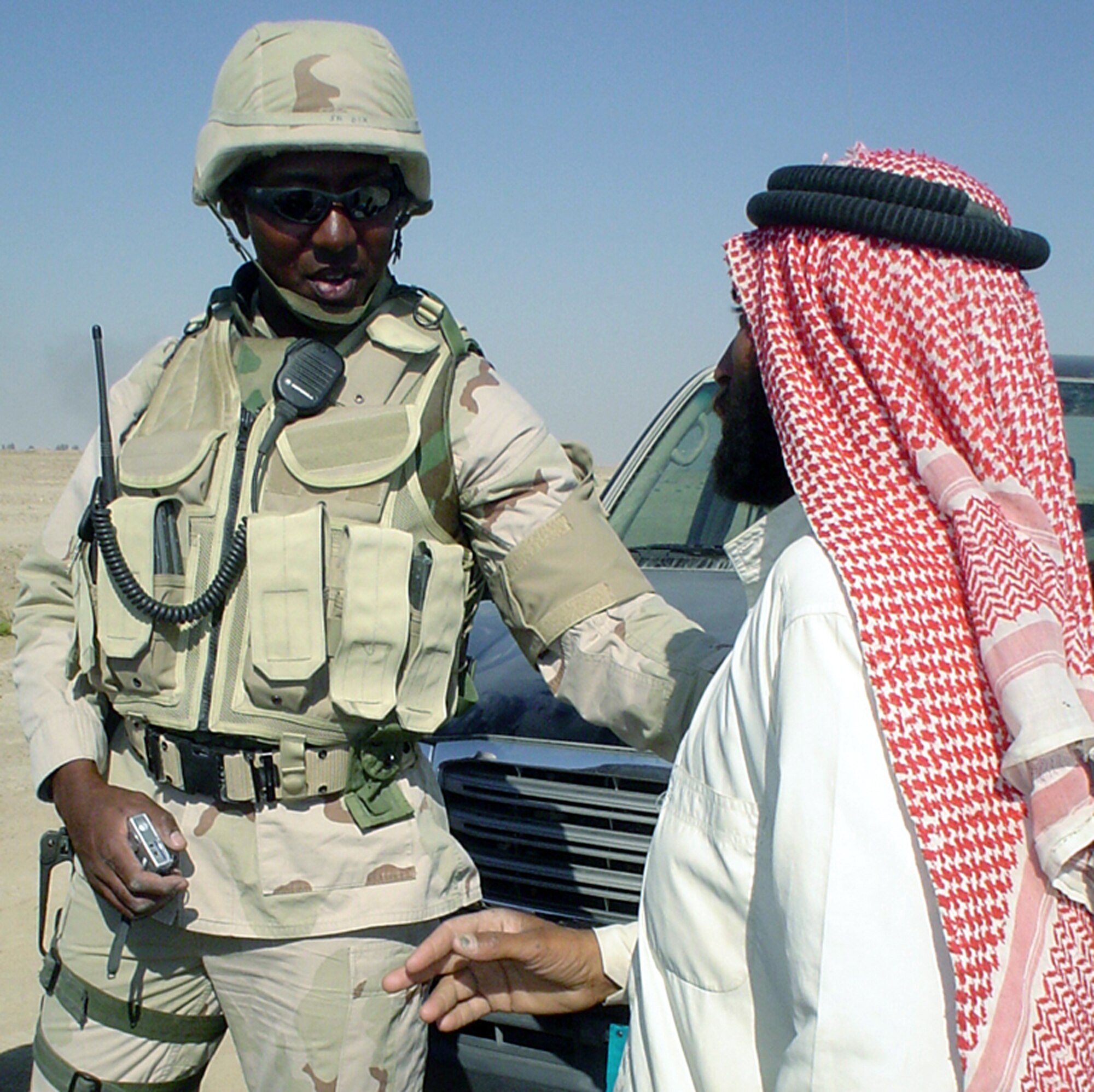 TALLIL AIR BASE, Iraq -- Senior Master Sgt. Don Dixon talks with a local Bedouin family leader during an Operation Reach Out visit near here.  Sergeant Dixon began the operation to establish a rapport with families living near the base.  He is the 407th Expeditionary Security Forces Squadron's operations superintendent.  (U.S. Air Force photo by Master Sgt. Debbie Aragon)