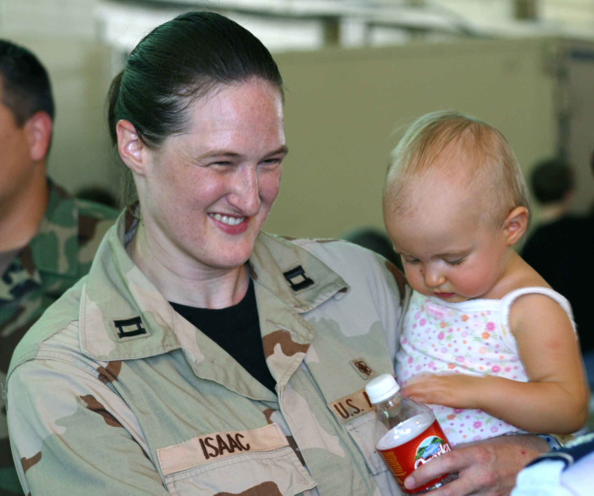 LACKLAND AIR FORCE BASE, Texas -- Capt. Kimberly Isaac holds her daughter one last time before deploying to Iraq on Aug. 30.  About 160 Airmen from the 59th Medical Wing at Wilford Hall Medical Center here left to staff a field hospital in Iraq.  (U.S. Air Force photo by 1st Lt. Benjamin Silva)