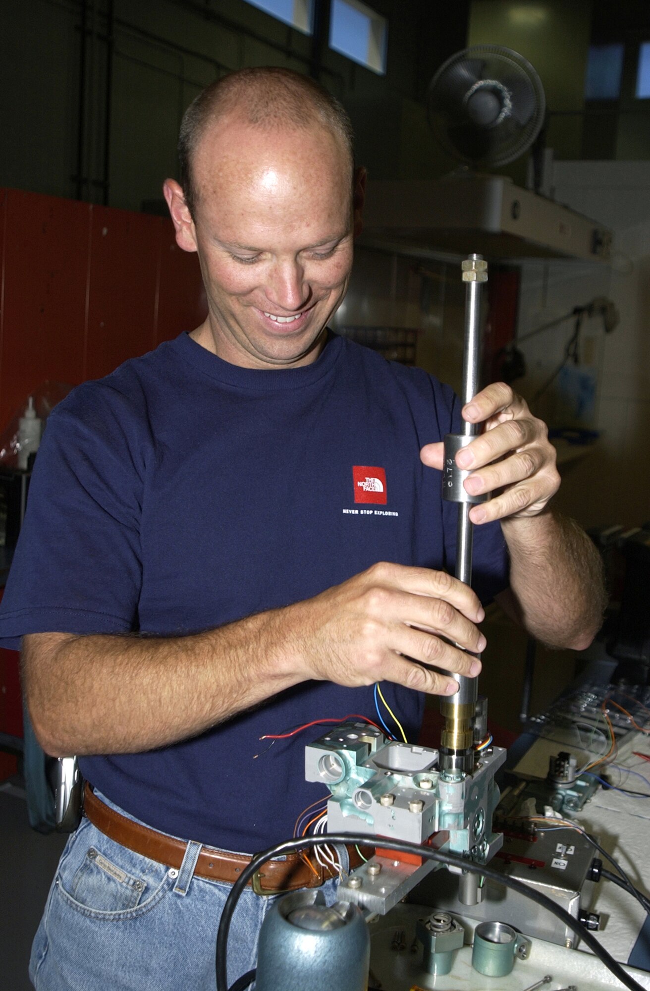 HILL AIR FORCE BASE, Utah -- Brett Harris demonstrates the puller tool he developed that helps take F-15 Eagle pitch trim controllers apart so they can be cleaned and refurbished without damaging them.  Mr. Harris' suggestion through the Innovative Development through Employee Awareness saved the Air Force $41,317 and earned him $6,200.  (U.S. Air Force photo by Beth Young)