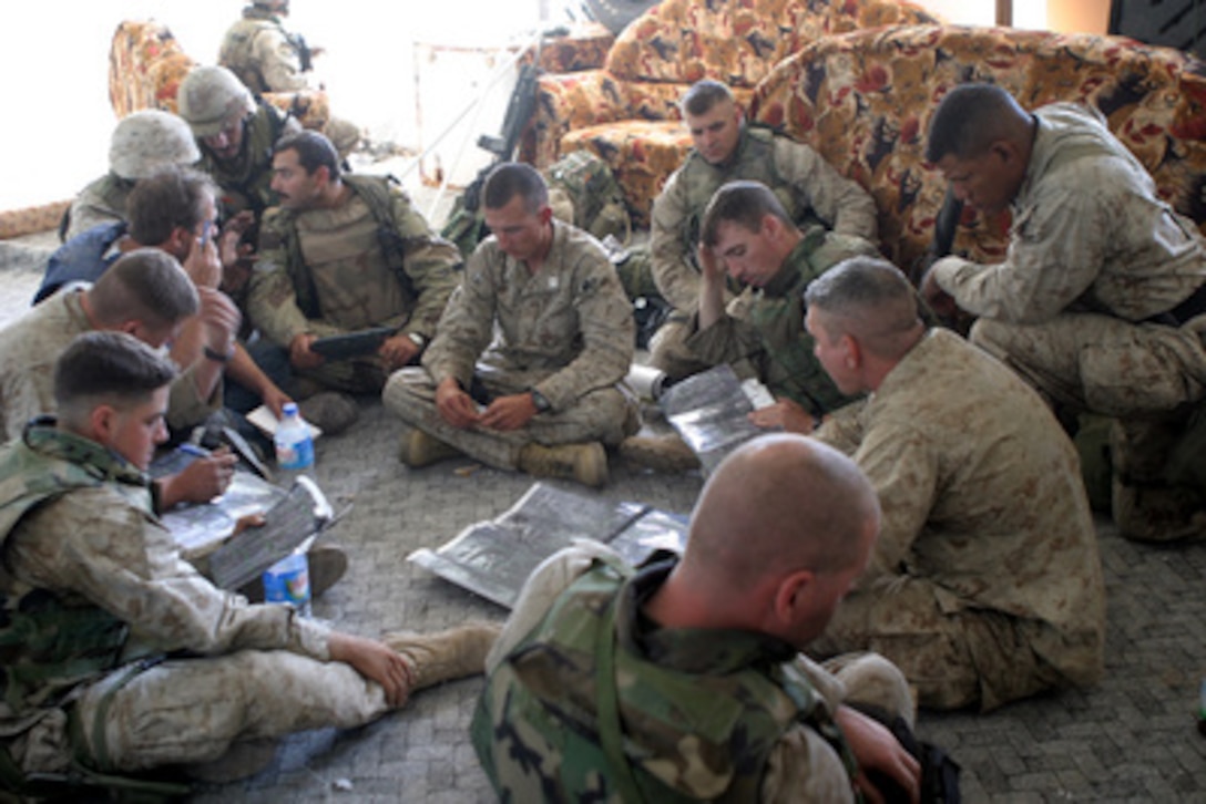 U.S. Marines, assigned to 1st Battalion, 8th Marines, 1st Marine Division, confirm map details about Fallujah, Iraq, before continuing patrols during Operation al Fajr (New Dawn) on Nov. 12, 2004. The 1st Marine Division is conducting security and stabilization operations in the Al Anbar Province of Iraq. 