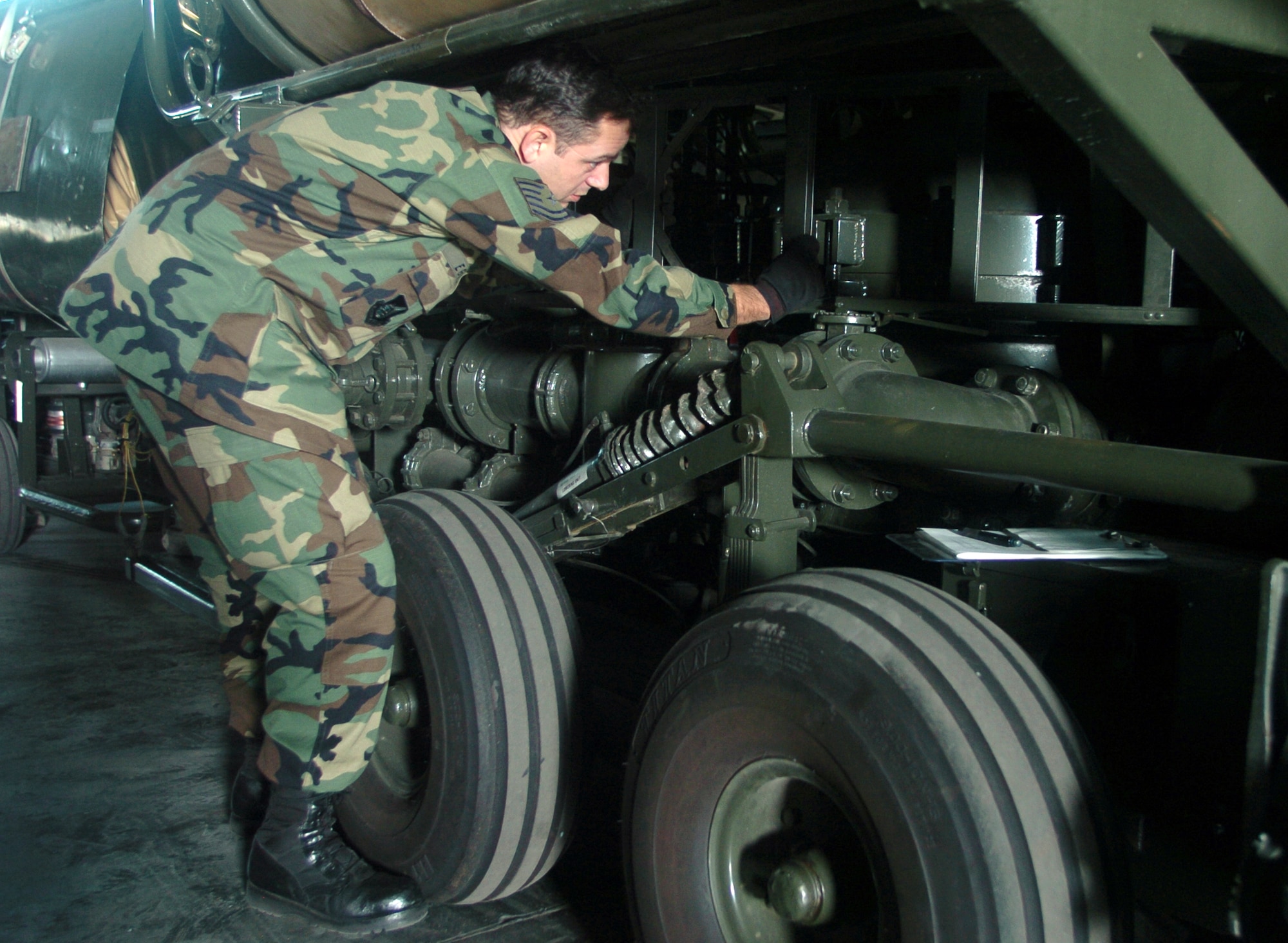 YOKOTA AIR BASE, Japan -- Tech. Sgt Charles Egri checks an R-14 air transportable hydrant refueling system during inspection here.  The R-14 can be airlifted or ground shipped anywhere in the world and made fully operational in a matter of hours.  Each unit contains a pump; two 50,000-gallon bladder tanks; and all the hoses, valves, and fittings necessary for operation.  Sergeant Egri is the 374th Logistics Readiness Squadron's fuels mobility support equipment element team chief.  (U.S. Air Force photo by Master Sgt. Val Gempis) 