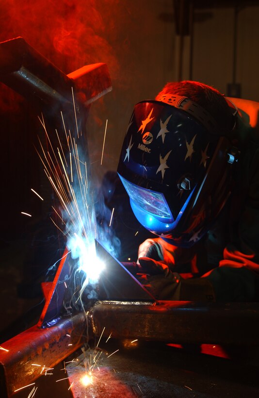 KUNSAN AIR BASE, South Korea -- Senior Airman Brad Duncan uses a welder to repair a munitions stand here Nov. 30.  He is assigned to the 8th Maintenance Squadron's fabrication shop.  (U.S. Air Force Photo by Staff Sgt. Michael R. Holzworth) 