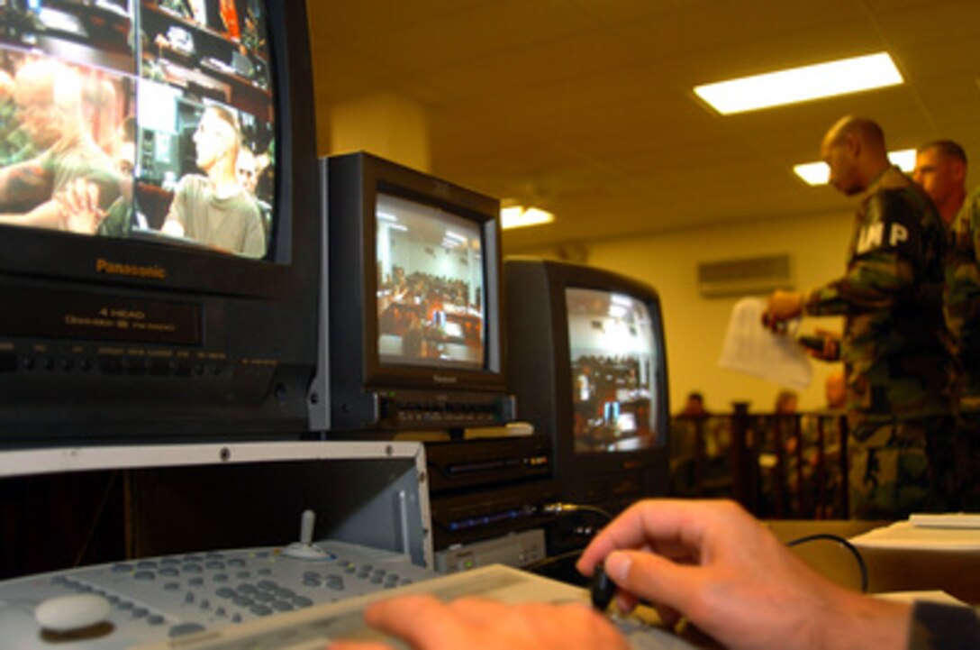 A closed-circuit television system is tested during a commissions rehearsal in the Joint Task Force Guantanamo courtroom at Guantanamo Bay, Cuba, on Oct. 29, 2004. During the commissions, a live video feed of the proceedings are sent to an auditorium at nearby Bulkeley Hall for members of the news media to watch and report on. The first U.S. military commissions in more than 50 years took place in this courtroom from August 24th through August 27th of 2004. Military commissions have historically been used to try violations of the law of war. Panels are comprised of three to seven military officers who vote on findings and if necessary, on sentences. 