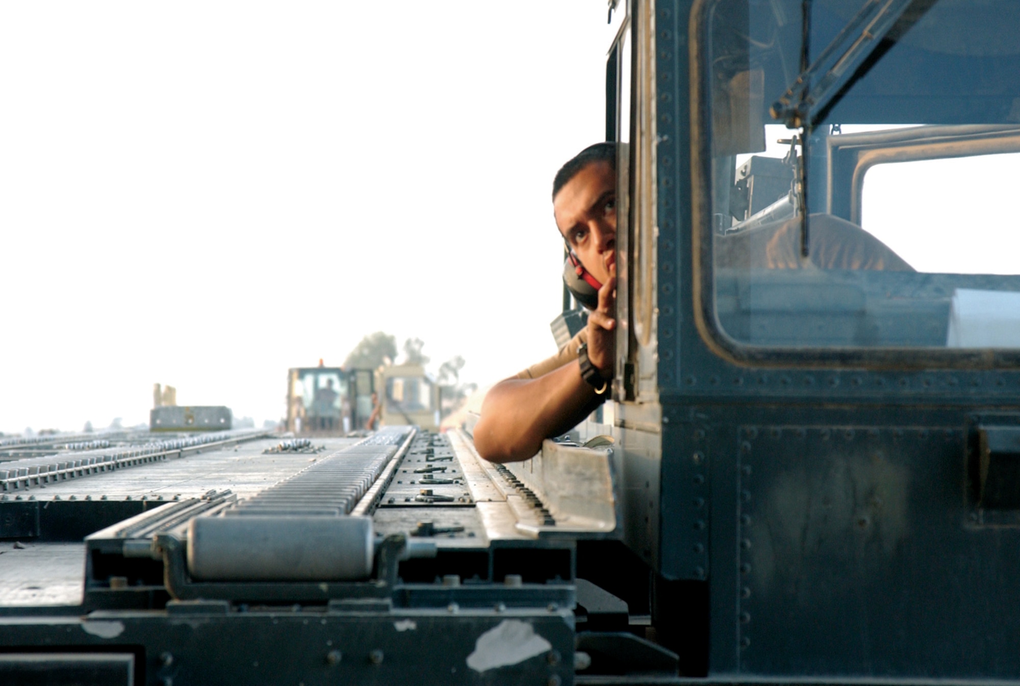 BALAD AIR BASE, Iraq -- Senior Airman Roberto Vasquez maneuvers a 60K loader to the rear of a C-17 Globemaster III to unload cargo here. Airman Vasquez is assigned to the 332nd Expeditionary Logistics Readiness Squadron. (U.S. Air Force Photo by Tech. Sgt. Marc Barnes)