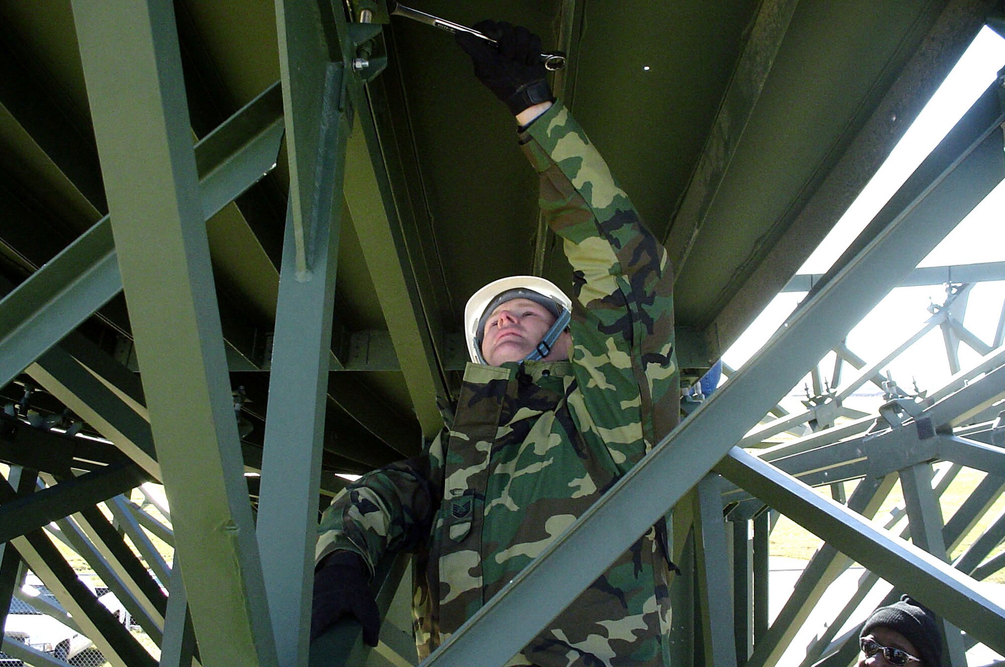 LANGLEY AIR FORCE BASE, Va. -- Tech. Sgt. Donald Zehner bolts a satellite dish panel into place here during installation of a Transportable Medium Earth Terminal II satellite communications system.  The system will speed the flow of information to warfighters from U-2 Dragon Lady reconnaissance flights.  Sergeant Zehner is a satellite communications maintenance technician assigned to the 10th Intelligence Squadron.  (U.S. Air Force photo by Tech. Sgt. Marina Pevey)