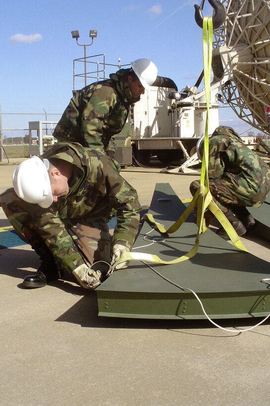 LANGLEY AIR FORCE BASE, Va. -- Senior Airman Lee Scott hooks a satellite dish panel to a crane here during installation of a Transportable Medium Earth Terminal II satellite communications system.  The system will speed the flow of information to warfighters from U-2 Dragon Lady reconnaissance flights.  Sergeant Scott is a satellite communications maintenance technician assigned to the 10th Intelligence Squadron.  (U.S. Air Force photo by Tech. Sgt. Marina Pevey)