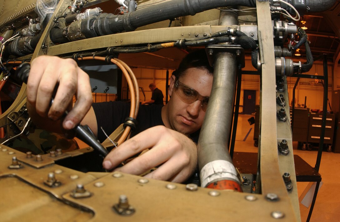 LUKE AIR FORCE BASE, Ariz. -- Airman Paul Lessard checks for any damaged or missing clamps before a quality assurance inspection here recently.  Airman Lessard is an F-16 crew chief assigned to the 56th Equipment Maintenance Squadron.  (U.S. Air Force photo by Staff Sgt. David Miller)