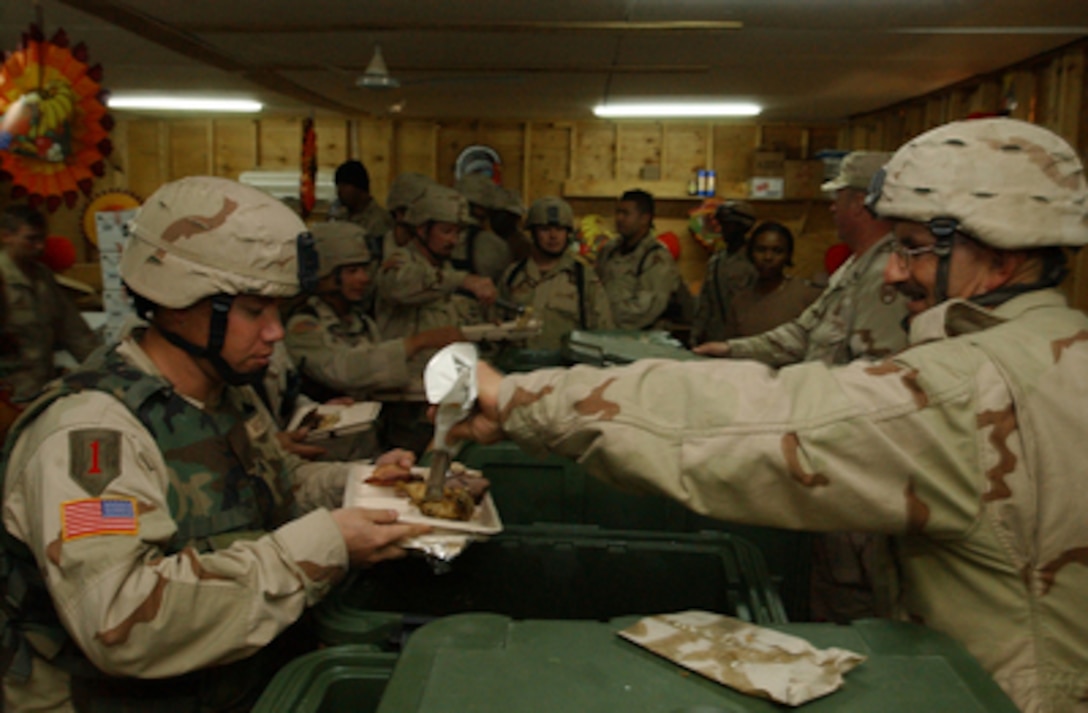 U.S. Army soldiers line up for Thanksgiving dinner at Camp Cobra in Iraq on Nov. 25, 2004. The soldiers are assigned to 30th Brigade Combat Team, a comprised unit made up of over 5000 North Carolina Air National Guard personnel. 