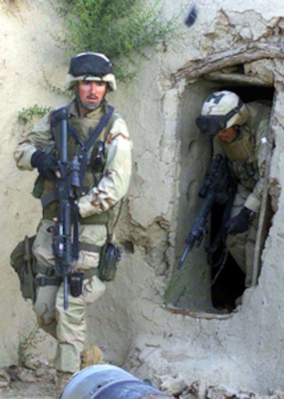 U.S. Marine Corps Cpl. Sean Field steps away from a house in the Oruzgan Province of Afghanistan on April 28, 2004. Field is assigned as a fire team leader with Charlie Company, Battalion Landing Team, 1st Battalion, 6th Marine Regiment. The battalion is the ground combat element of the 22nd Marine Expeditionary Unit in Afghanistan conducting combat and civil military operations. 