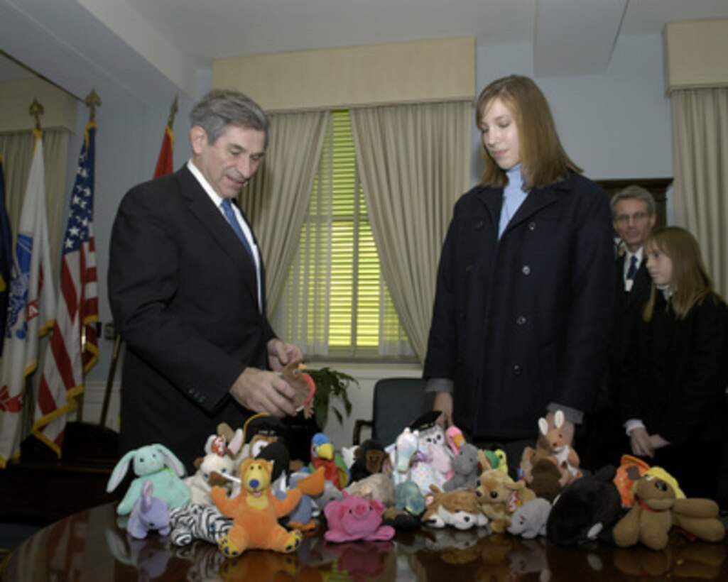 Alison Goulder shows Deputy Secretary of Defense Paul Wolfowitz a small sampling of the stuffed animals being sent to Iraqi children during their meeting in the Pentagon on Dec. 3, 2004. Goulder, her family and her school, Rancho Solano in Scottsdale, Ariz., collected over 28,000 of these toys as part of Operation Grateful, an effort to send care packages to troops in Iraq, Afghanistan, and Germany. Soldiers have asked for these toys to give to the children they come in contact with as they patrol in Iraq and Afghanistan. 