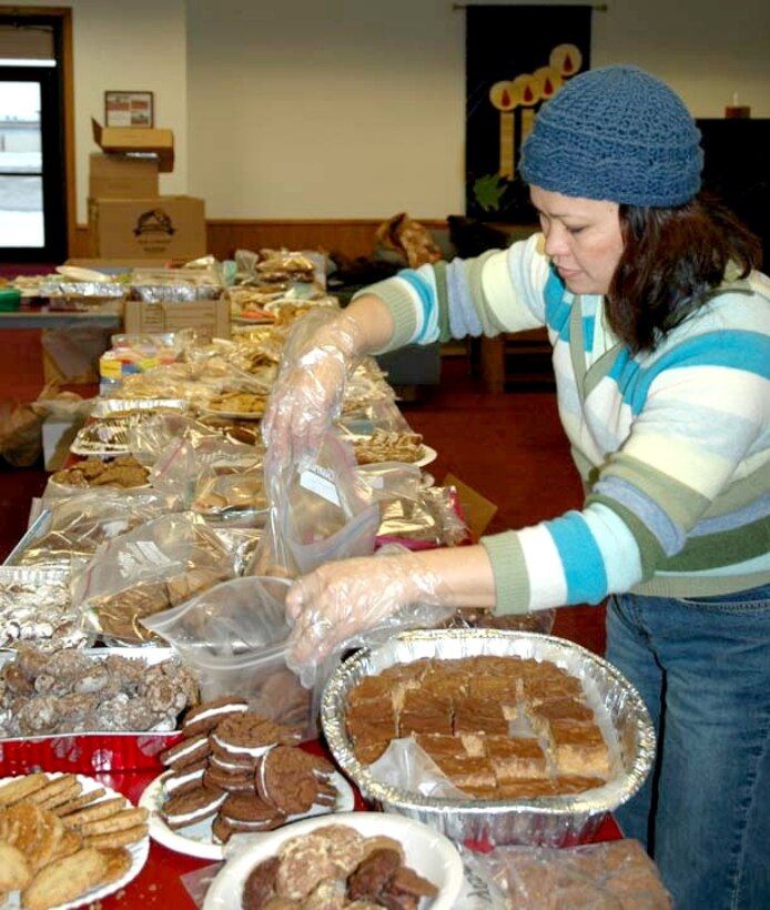 MINOT AIR FORCE BASE, N.D -- Elsa Wong sorts cookies during the base's annual cookie drive at the chapel here Dec. 7.  Volunteers from the base and local community baked nearly 17,000 cookies for dormitory residents here as part of the drive.  Children from the base's two elementary schools made Christmas cards to attach to the plates of goodies.  When handed out during the holiday season, each dorm resident will receive about 18 cookies.  (U.S. Air Force photo by Airman 1st Class Danny Monahan)