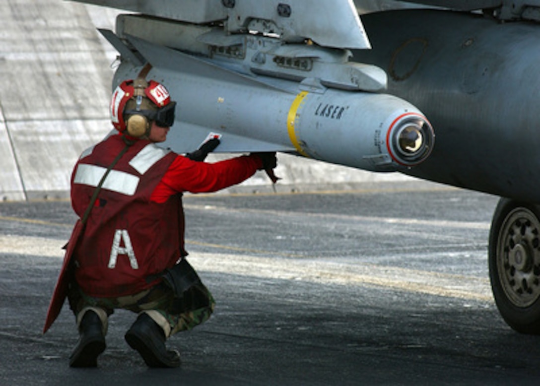 Petty Officer 3rd class William Miller arms an AGM-65 Maverick laser-guided missile mounted on an F/A-18 Hornet before the aircraft is launched from the flight deck of the aircraft carrier USS Harry S. Truman (CVN 75) on Nov. 28, 2004. The AGM-65 Maverick is an air-to-surface missile designed for close air support, interdiction and defense suppression. Truman's Carrier Strike Group 10 and embarked Carrier Air Wing 3 are deployed in support of the Global War on Terror. Miller is a Navy aviation ordnanceman assigned to Strike Fighter Squadron 105. 