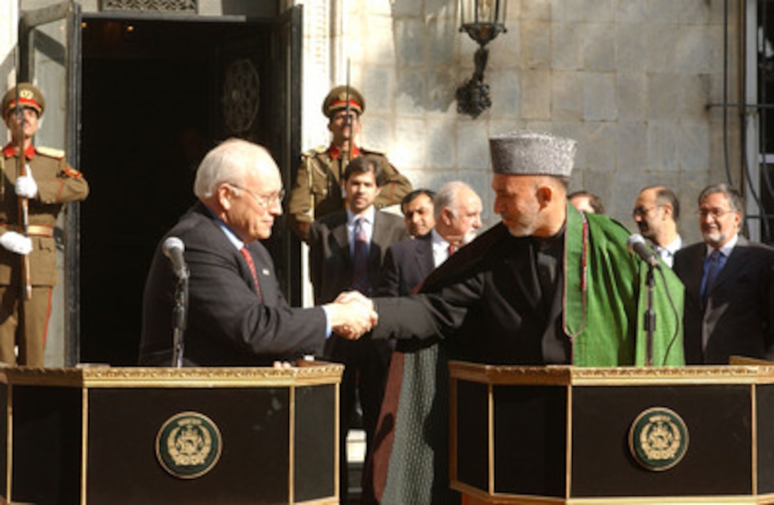 Vice President Richard B. Cheney (left) and Afghanistan President Hamid Karzai shake hands after a press conference at the Presidential Palace in Kabul, Afghanistan, on Dec. 7, 2004. Cheney and Secretary of Defense Donald H. Rumsfeld are in Afghanistan to attend the first Presidential Inauguration of Afghanistan President Hamid Karzai and to visit troops deployed for Operation Enduring Freedom. 