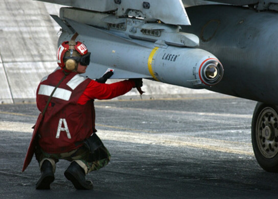 Petty Officer 3rd class William Miller arms an AGM-65 Maverick laser-guided missile mounted on an F/A-18 Hornet before the aircraft is launched from the flight deck of the aircraft carrier USS Harry S. Truman (CVN 75) on Nov. 28, 2004. The AGM-65 Maverick is an air-to-surface missile designed for close air support, interdiction and defense suppression. Truman's Carrier Strike Group 10 and embarked Carrier Air Wing 3 are deployed in support of the Global War on Terror. Miller is a Navy aviation ordnanceman assigned to Strike Fighter Squadron 105. 