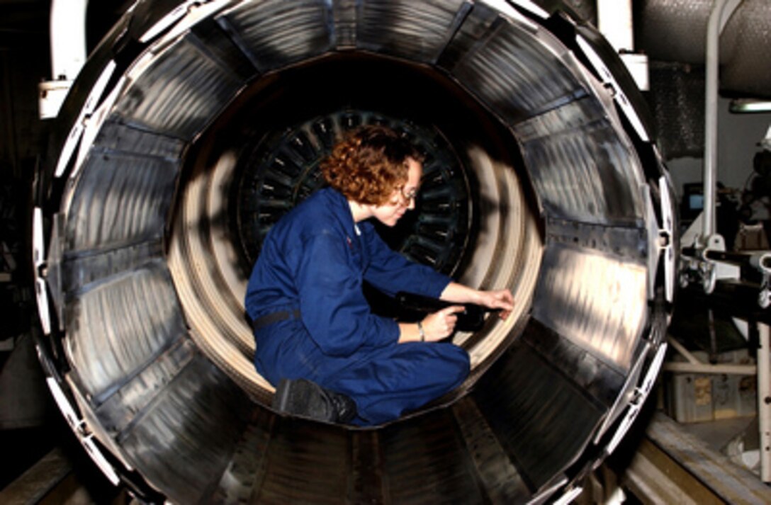 Petty Officer 2nd class Dawn Leclair performs maintenance on a General Electric F110-GE-400 jet engine in the Jet Shop aboard the aircraft carrier USS Harry S. Truman (CVN 75) underway in the Persian Gulf on Nov. 29, 2004. The F110-GE-400 engine is used by the F-14B Tomcats assigned to Fighter Squadron 32. Truman's Carrier Strike Group Ten 10 and embarked Carrier Air Wing 3 are deployed in support of the Global War on Terror. Leclair is a Navy aviation machinist's mate. 