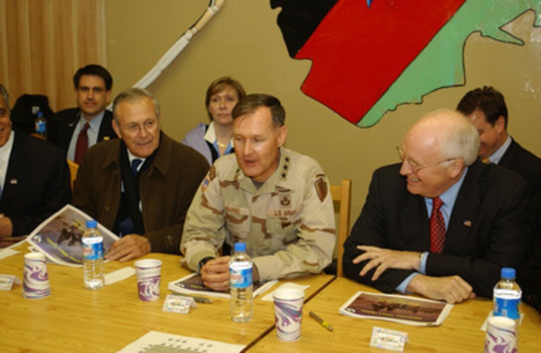 Secretary of Defense Donald H. Rumsfeld (left), U.S. Army Lt. Gen. David W. Barno, commander, Combined Forces Command Afghanistan (center) and Vice President Richard B. Cheney receive a Afghanistan Military Update briefing at Bagram Air Base, Afghanistan, on Dec. 7, 2004. Rumsfeld and Cheney are in Afghanistan to attend the first Presidential Inauguration of Afghanistan President Hamid Karzai and to visit troops deployed for Operation Enduring Freedom. 