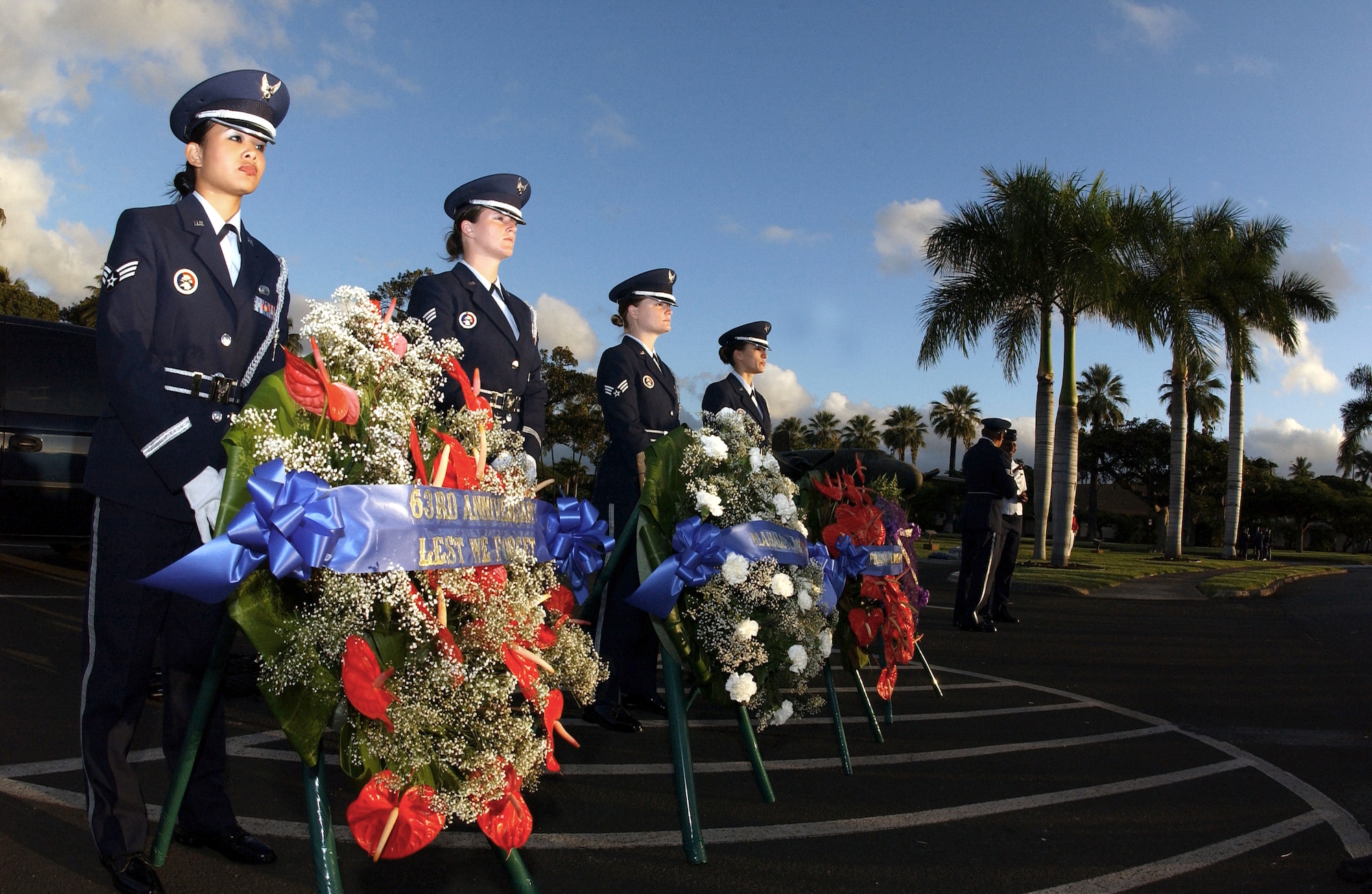HICKAM AIR FORCE BASE, Hawaii -- Airmen of the base honor guard here prepare to place memorial wreaths during the ceremony commemorating the 63rd anniversary of the attack on Hickam Field on Dec. 7, 1941.  The Airmen (from left) are Senior Airmen Jodi Asprer, April Bonaparte and Leslie Ocasio-Gonzalez, and Airman 1st Class Jennifer Kincaid.  (U.S. Air Force photo by Mysti Bicoy)