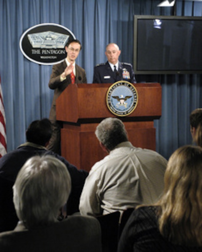 Deputy Under Secretary of Defense for Personnel and Readiness David S. C. Chu (left) is joined by Air Force Vice Chief of Staff Gen. T. Michael Moseley (right) to present the DoD Inspector General Report on Air Force Academy Sexual Misconduct during a Pentagon press briefing on Dec. 7, 2004. 