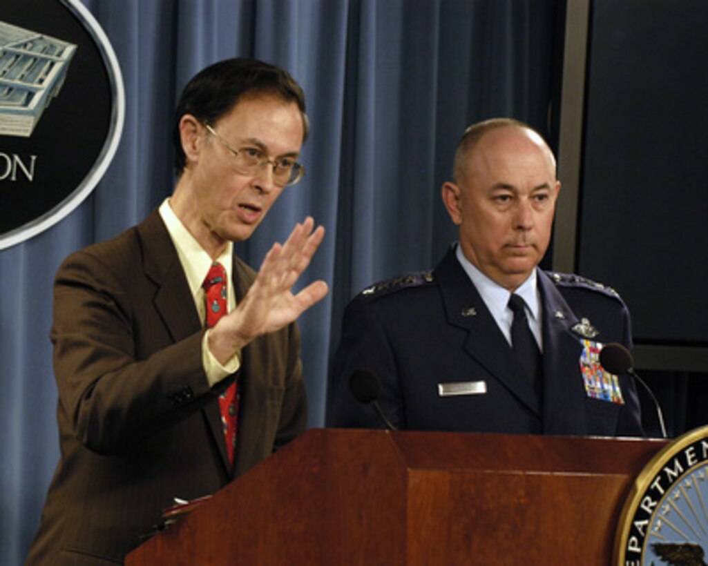 Deputy Under Secretary of Defense for Personnel and Readiness David S. C. Chu (left) is joined by Air Force Vice Chief of Staff Gen. T. Michael Moseley (right) to present the DoD Inspector General Report on Air Force Academy Sexual Misconduct during a Pentagon press briefing on Dec. 7, 2004. 