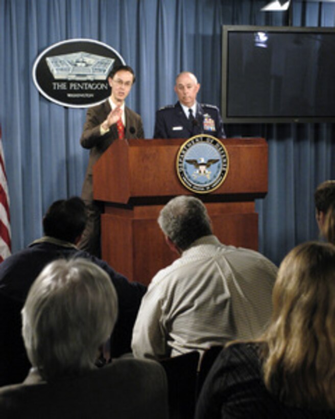 Deputy Under Secretary of Defense for Personnel and Readiness David S. C. Chu (left) is joined by Air Force Vice Chief of Staff Gen. T. Michael Moseley (right) to present the DoD Inspector General Report on Air Force Academy Sexual Misconduct during a Pentagon press briefing on Dec. 7, 2004. 