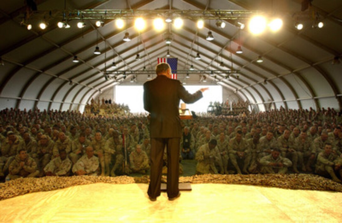 Secretary of Defense Donald H. Rumsfeld talks to service members during a town hall style meeting at Camp Buehring, Kuwait, on Dec. 8, 2004. Rumsfeld is in Kuwait to meet and talk with deployed troops. Rumsfeld will later meet with the Kuwaiti leadership to thank them for their support in the global war on terror and Operation Iraqi Freedom. 