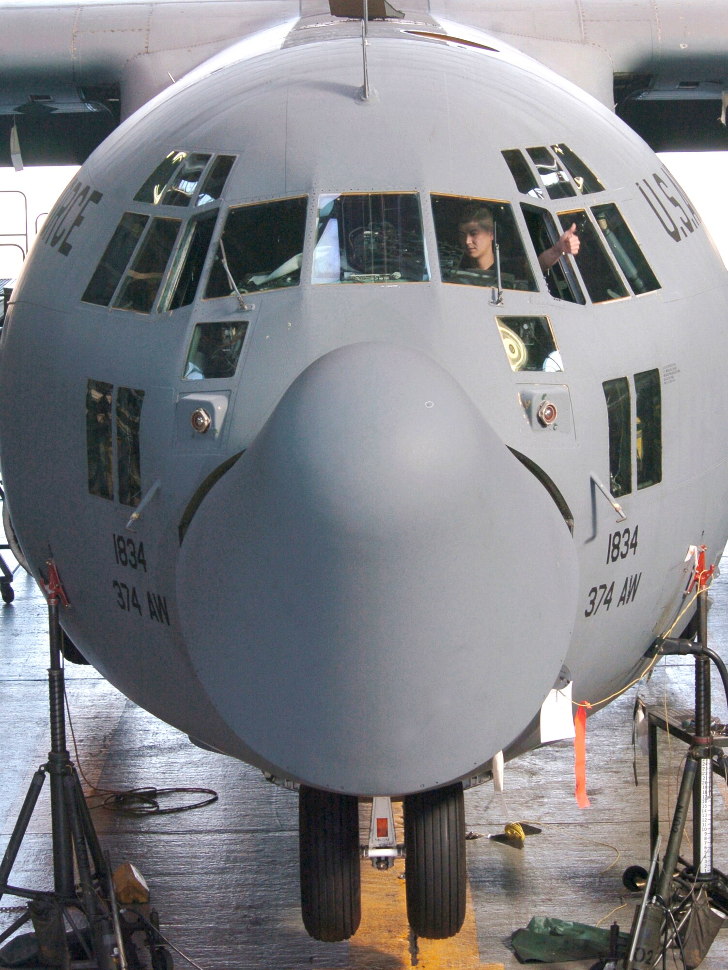 YOKOTA AIR BASE, Japan -- Staff Sgt. Shayn Powers gives a thumbs up while inspecting inside the cockpit of a C-130 Hercules during an annual inspection here. Sergeant Powers is a field training instructor from the 372nd Training Squadron.  (U.S. Air Force photo by Master Sgt. Val Gempis)
