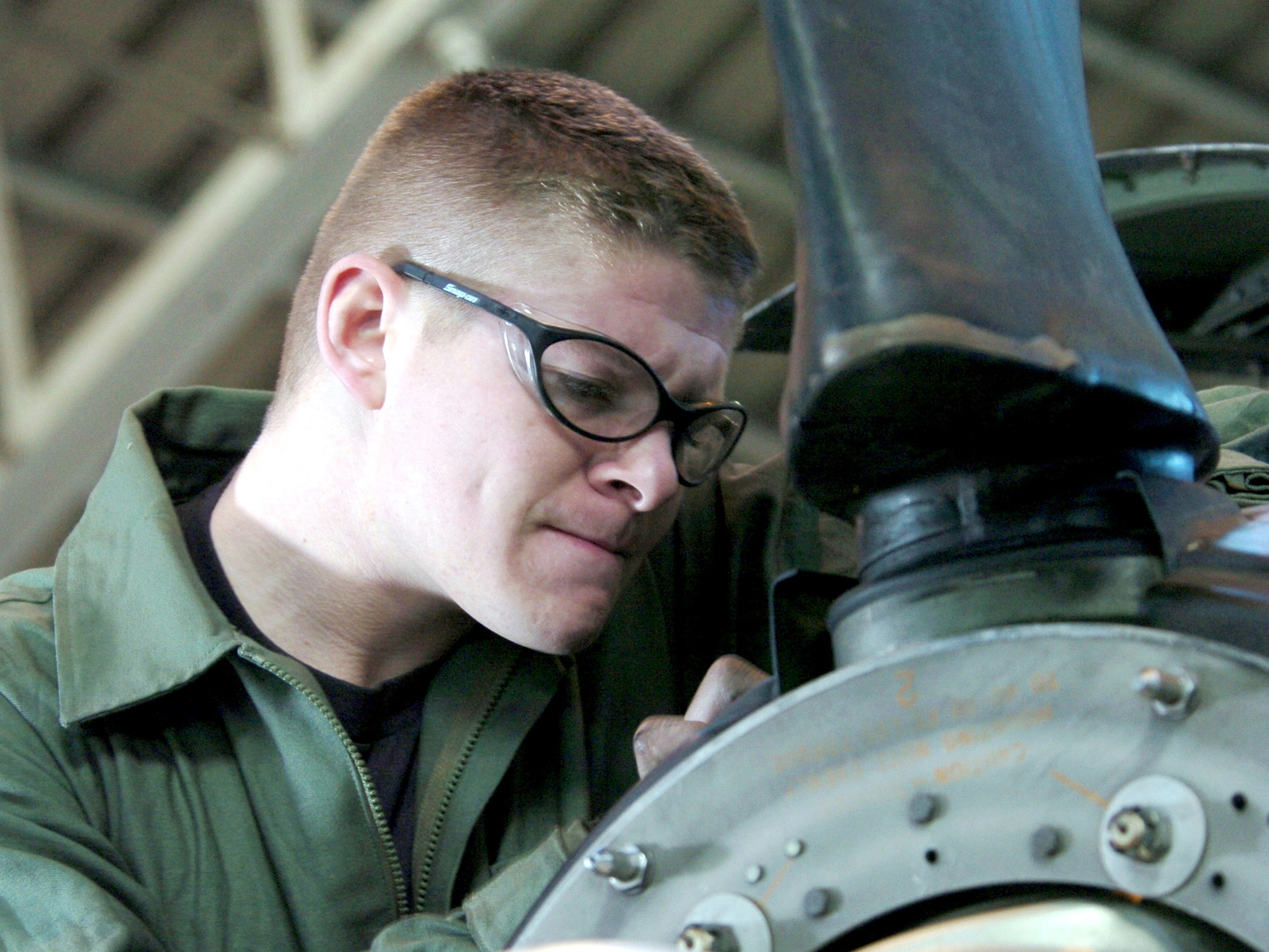 YOKOTA AIR BASE, Japan -- Airman 1st Class Matthew McGonagle checks a C-130 Hercules engine.  The Airman and others in the 374th Maintenance Squadron's isochronal section conduct a rigorous annual check to ensure that the Pacific Air Force C-130 fleet is in top condition.  Airmen McGonagle is an engine specialist.  (U.S. Air Force photo by Master Sgt. Val Gempis)