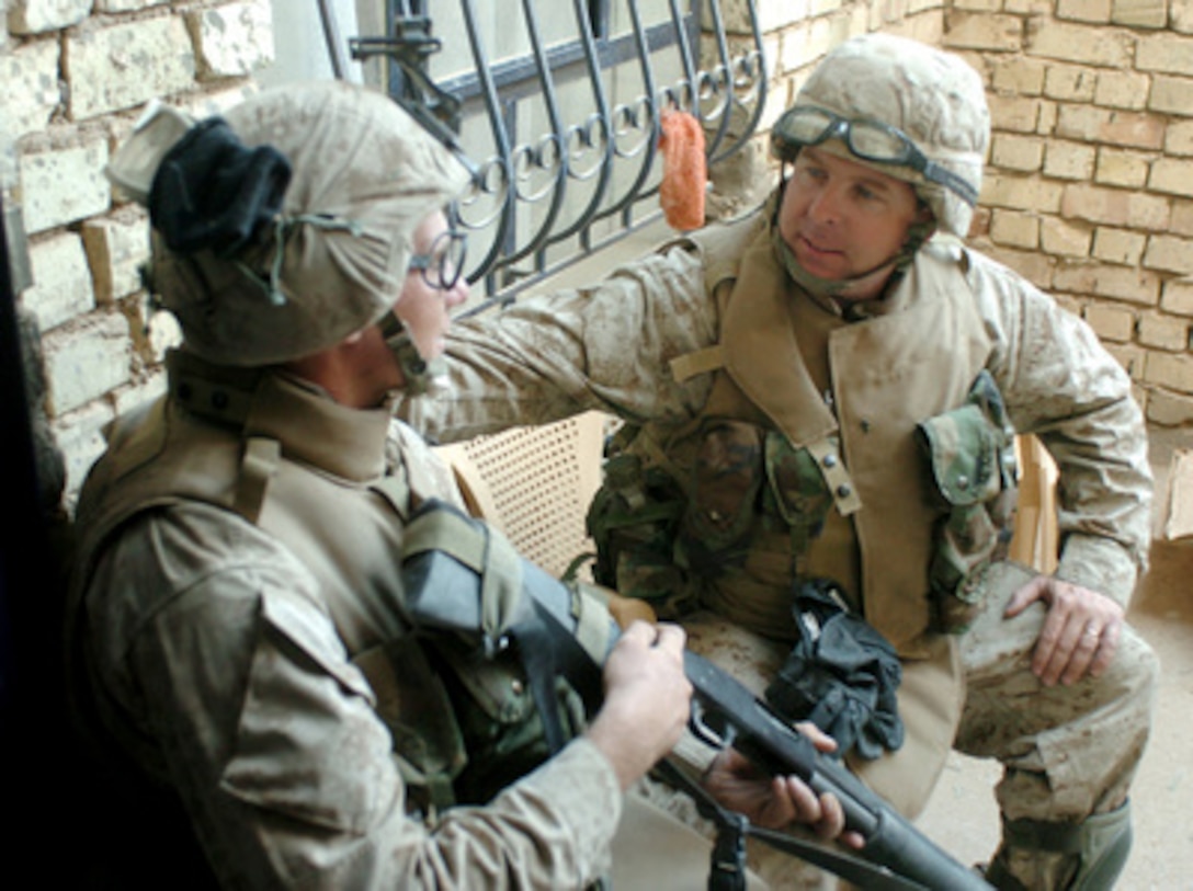 U.S. Navy Chaplain Lt. Kenny Lee talks with Lance Cpl. Kris Latorre during Operation al Fajr (New Dawn) in Fallujah, Iraq, on Nov. 29, 2004. Operation al Fajr is an offensive operation to eradicate insurgent forces within the city of Fallujah in support of continuing security and stabilization operations in the Al Anbar province of Iraq. Latorre is assigned to 3rd Platoon, Charlie Company, 3rd Marine Regiment. 