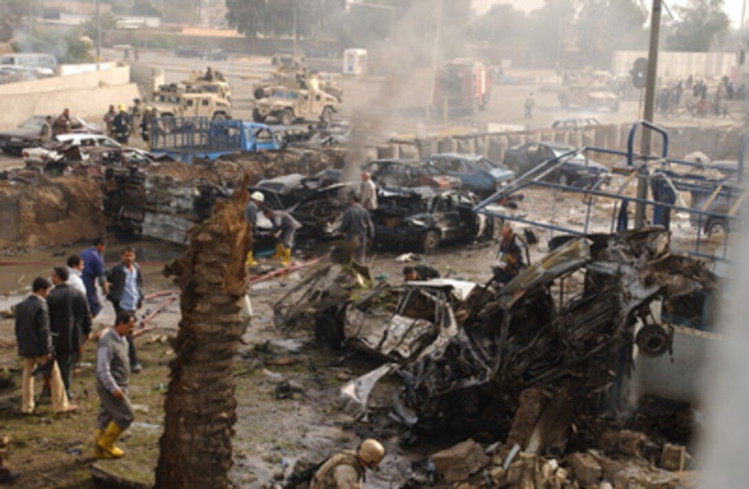 Smoke fills the air after a car bomb was detonated in the parking lot of an Iraqi police station outside the gate of the Green Zone near the Al-Rasheed Hotel in Baghdad, Iraq, on Dec. 4, 2004. Coalition and Iraqi forces rushed to the scene to help the wounded and put out the fires. 