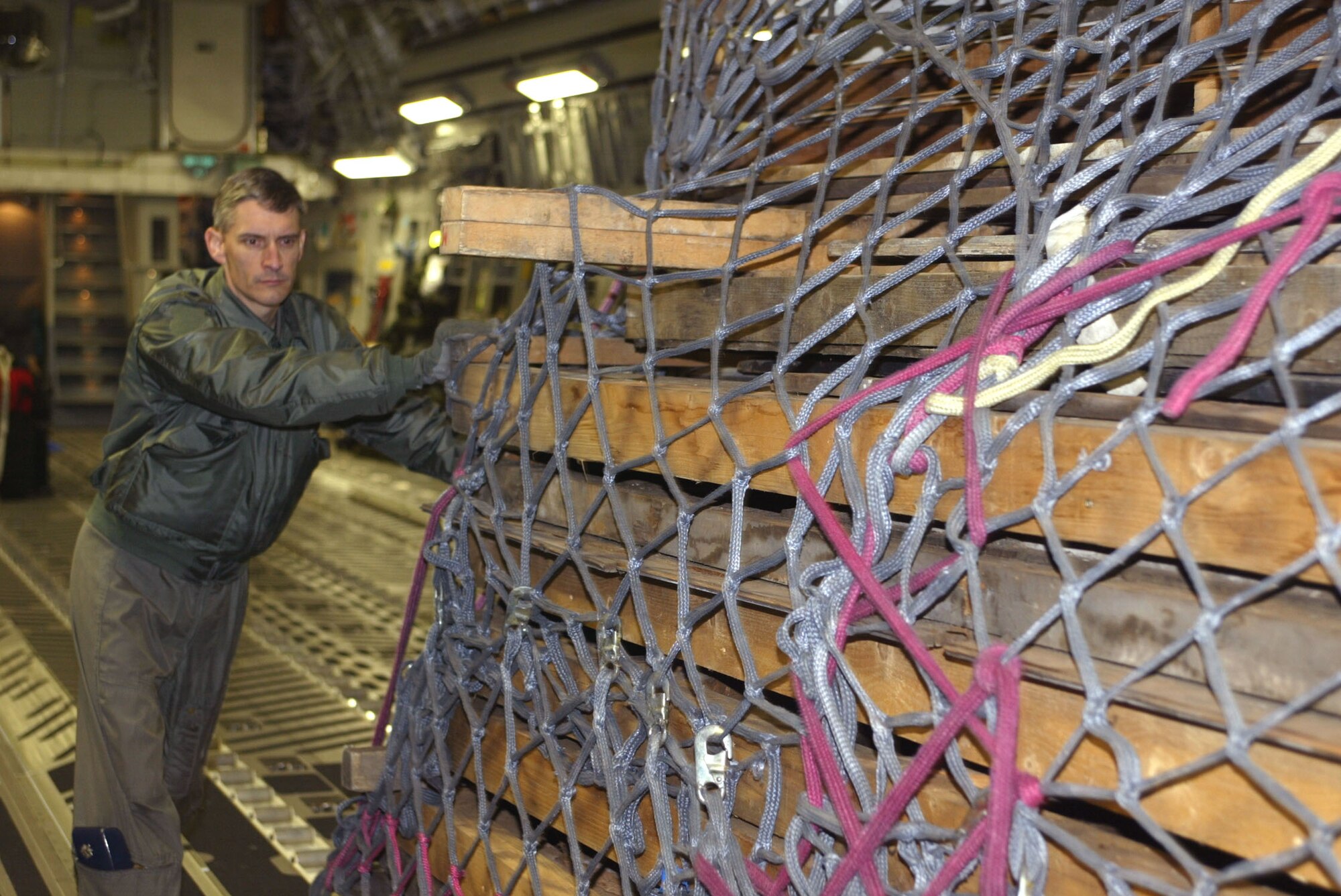 DOBBINS AIR RESERVE BASE, Ga. -- Lt Col William Hill helps offload one of the pallets containing the last remaining war stable from a C-17 Globemaster III here.  The stable was the D-Day home for the 506th Parachute Infantry Regiment, known as the Band of Brothers.  Originally located on a farm in south England, it was disassembled, palletized and transported to the United States on an Air National Guard C-17 from the 172nd Airlift Wing at Allen C. Thompson Field, Miss.  The stable will be transported to Camp Toccoa, Ga., where it will reassembled at a museum there.  Colonel Hill is the operations group commander for the 172nd AW.  (U.S. Air Force photo by Don Peek)