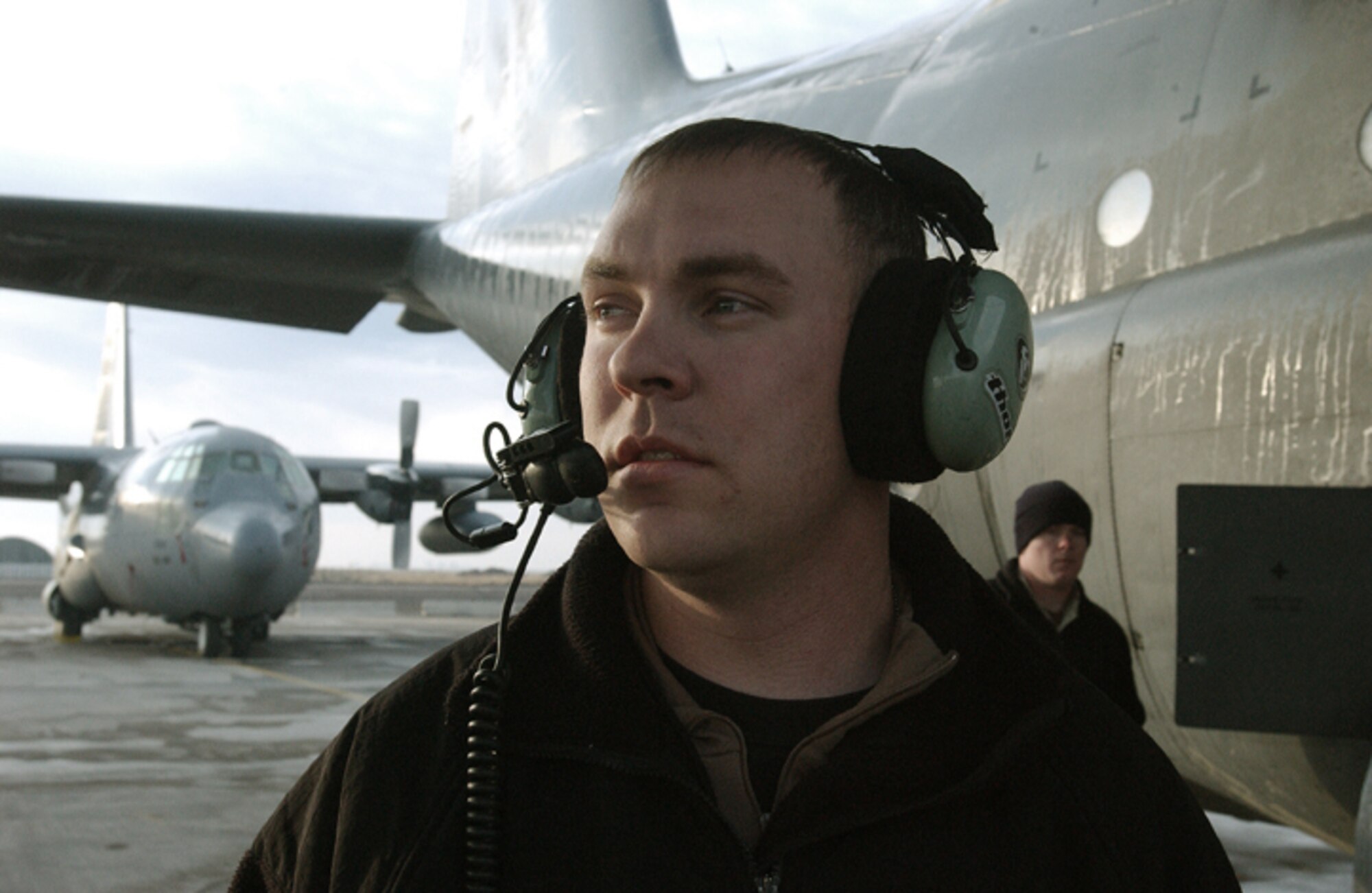 KARSHI-KHANABAD AIR BASE, Uzbekistan -- Senior Airman Wheldon Thorpe supervises an aircraft refueling.  Airman Thorpe and other maintainers from the 774th Expeditionary Airlift Squadron maintenance flight have helped the squadron maintain a 100 percent mission accomplishment rate for the past four months.  (U.S. Air Force photo by Senior Airman Matthew Rosine)
