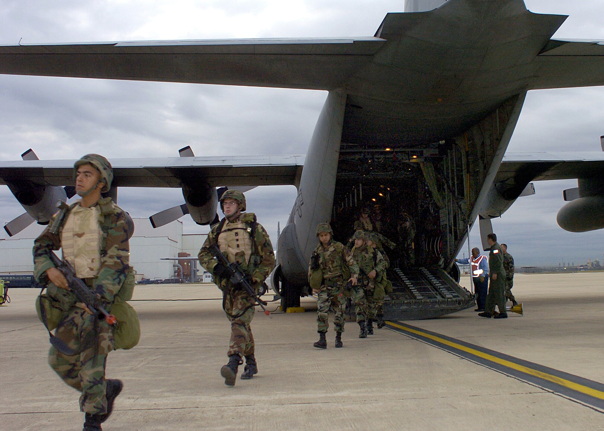 LACKLAND AIR FORCE BASE, Texas -- Soldiers from the 4th Infantry Division out of Fort Hood, Texas, file off of a C-130 Hercules for a Quick Reaction Force exercise here Dec. 8. The mission was to provide a flexible and responsive unit to a specific region in the event of a domestic threat or incident.   The exercise here trained the Soldiers to prepare for homeland defense missions. (U.S. Air Force photo by Staff Sgt. Derrick C. Goode)