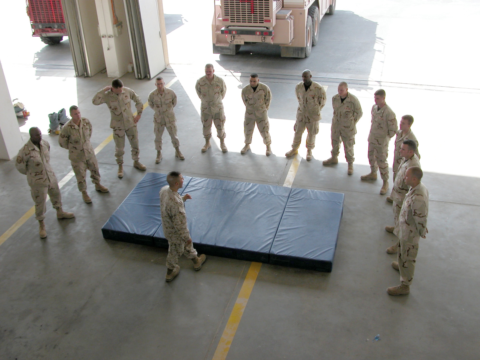 SOUTHWEST ASIA - Marine Sgt. Luis Mercado speaks to students at a deployed location after they have completed a tan belt martial arts certification. Sergeant Mercado teaches Marines Corps-style hand-to-hand combat training to Airmen on his off-duty time.(U.S. Air Force photo by Staff Sgt. Bryan Bouchard) 