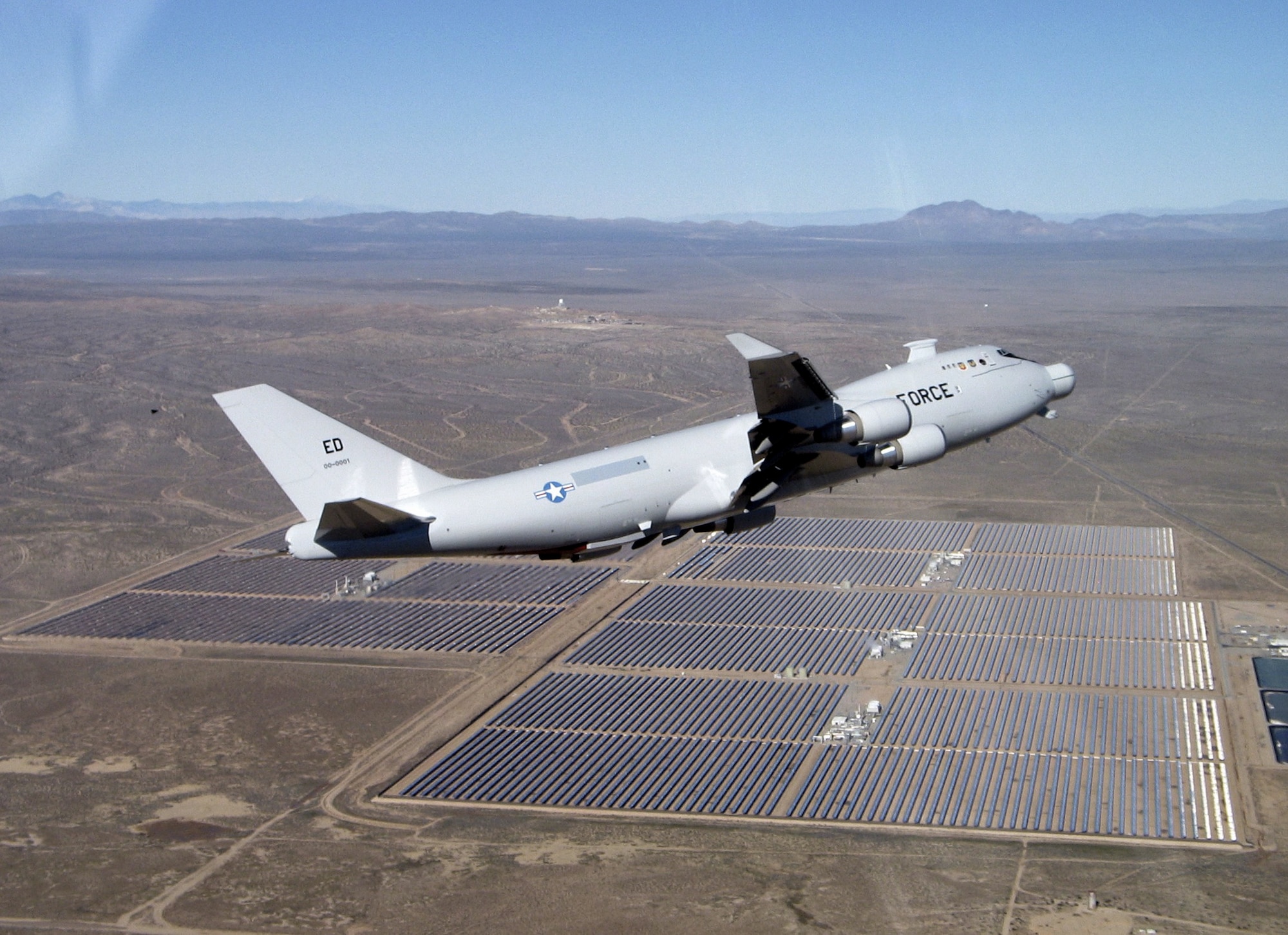 The YAL-1A Airborne Laser aircraft flew over the range at Edwards Air Force Base, Calif, Dec. 9, 2004,  while officials recertified the aircraft's airworthiness before resuming testing of the system's laser beam control system.  The aircraft had been out of service for modifications.  (Courtesy photo)

