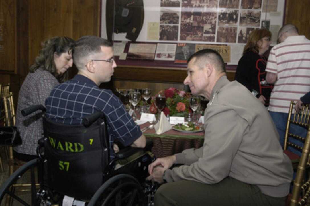 Vice Chairman of the Joint Chiefs of Staff Gen. Peter Pace (right), U.S. Marine Corps, speaks with one of the wounded military personnel invited to the Pentagon for a holiday meal on Dec. 9, 2004. Deputy Secretary of Defense Paul Wolfowitz hosted the dinner in the Pentagon to honor some of the service men and women wounded in Iraq and Afghanistan and presently at Walter Reed Army Medical Center and Bethesda Naval Hospital. 