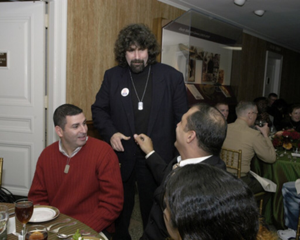 World Wrestling Federation champion Mick Foley (standing) thanks military personnel for their sacrifices while serving in the armed forces at a dinner in the Pentagon on Dec. 9, 2004. Deputy Secretary of Defense Paul Wolfowitz hosted the dinner in the Pentagon to honor some of the service men and women wounded in Iraq and Afghanistan and presently at Walter Reed Army Medical Center and Bethesda Naval Hospital. 