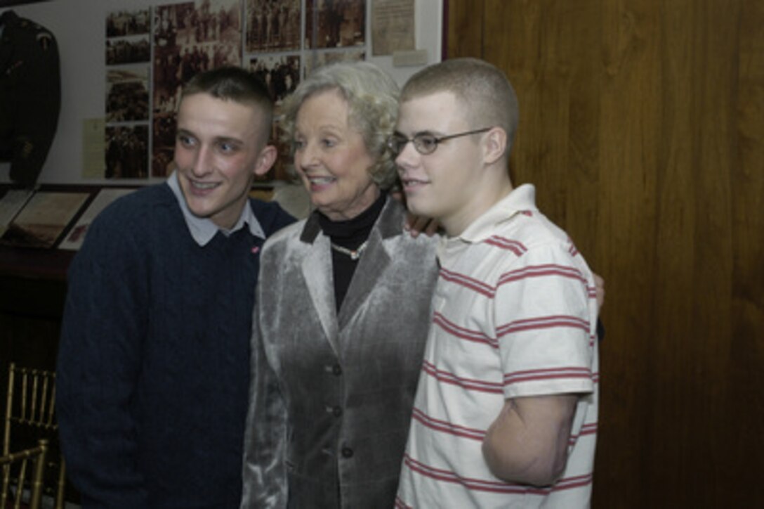 Joyce Rumsfeld, wife of Secretary of Defense Donald H. Rumsfeld, poses for photographs with two Marines at a Pentagon dinner honoring them on Dec. 9, 2004. Deputy Secretary of Defense Paul Wolfowitz hosted the dinner in the Pentagon to honor some of the service men and women wounded in Iraq and Afghanistan and presently at Walter Reed Army Medical Center and Bethesda Naval Hospital. 