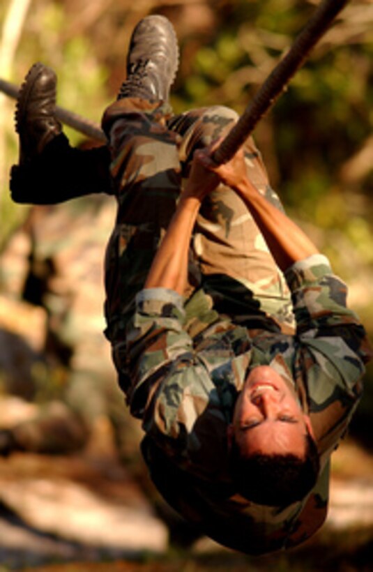 Air Force Tech. Sgt. Charles Rushing pulls himself along a rope during the Dragon Challenge '04 obstacle course at Avon Park Air Force Range, Fla., on Dec. 5, 2004. Rushing is a Tactical Air Control Party member from the 18th Weather Squadron at Pope Air Force Base, N.C. Dragon Challenge is an annual competition which tests the physical, mental, and emotional strength, and endurance of tactical air control party members over a four-day period. 