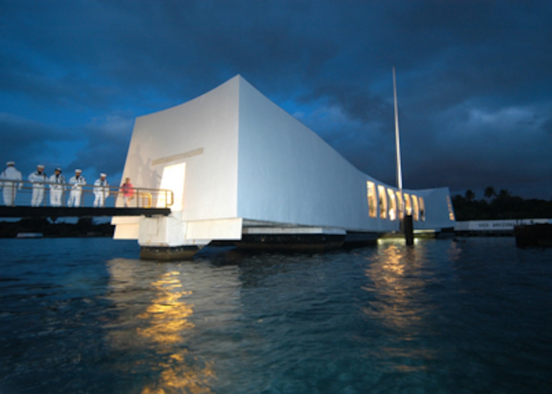 Sailors assigned to the ceremonial guard at Naval Station Pearl Harbor, Hawaii, practice early in the morning of Dec. 7, 2004, before the 63rd commemoration of the Dec. 7, 1941, attack on Pearl Harbor. More than 200 distinguished visitors and Pearl Harbor attack survivors will attend the ceremony which includes honors rendered by the destroyer USS Chung-Hoon (DDG 93), more than 40 wreath presentations, a 21-gun salute, and a missing man flyover. 