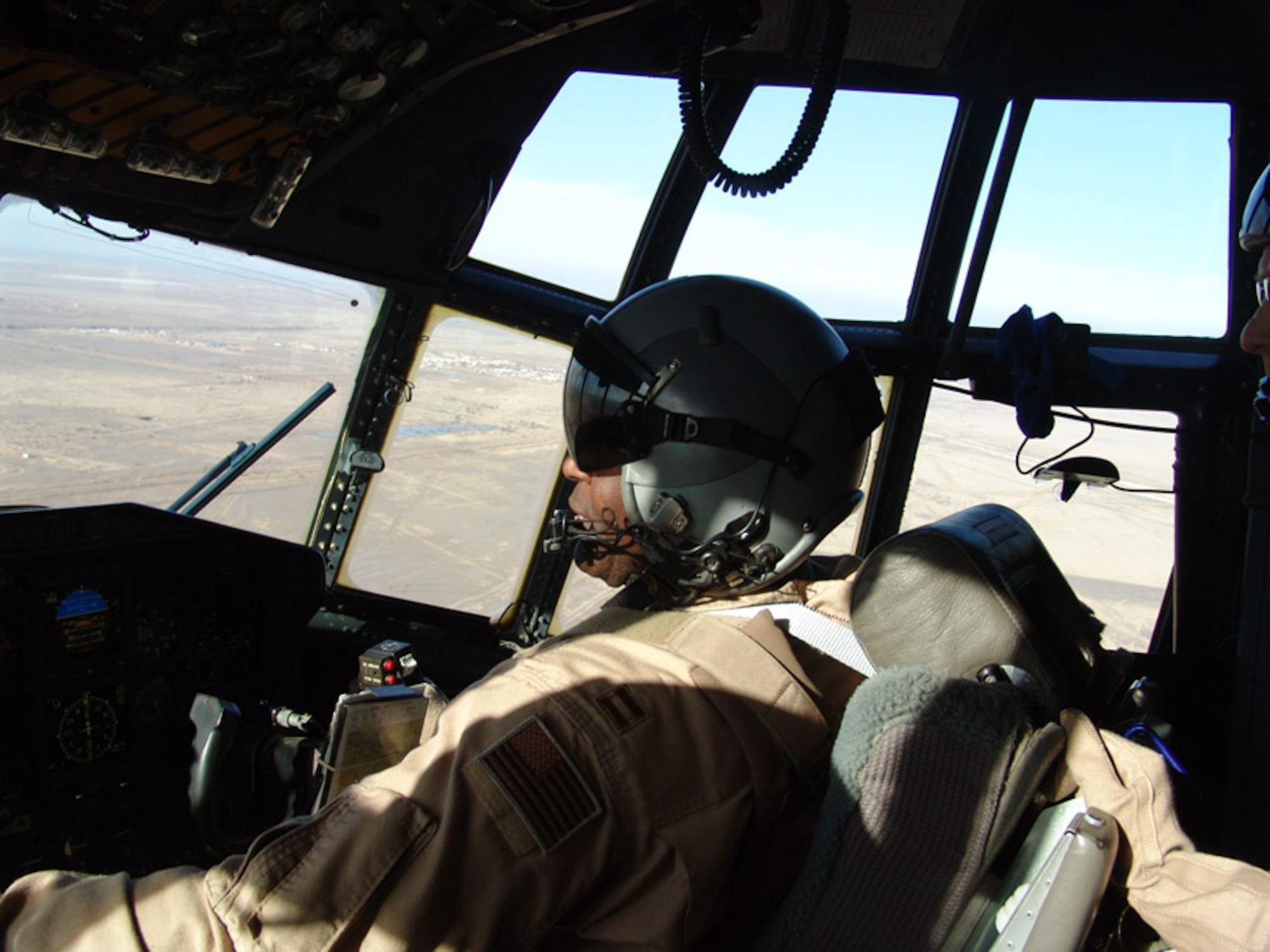 SOUTHWEST ASIA -- Capt. C.J. Charlton scans his instruments during a C-130 Hercules flight over Iraq.  During the past month, Air Force C-130 and C-17 Globemaster III aircraft have increased airlift operations assisting Soldiers in getting needed armored vehicles, repair parts and ammunition to troops in Iraq.  Captain Charlton is from the 746th Expeditionary Airlift Squadron.  (U.S. Air Force photo by Capt. Aaron Burgstein)