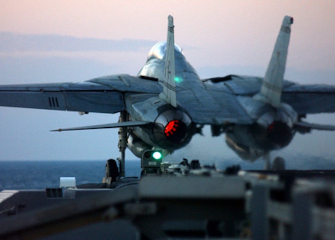 An F-14B Tomcat is catapulted from the flight deck of the aircraft carrier USS Harry S. Truman (CVN 75) during evening flight operations in the Persian Gulf on Dec. 4, 2004. Truman and its embarked Carrier Air Wing 3 are providing close air support and conducting intelligence, surveillance, and reconnaissance missions over Iraq. The Tomcat is assigned to Fighter Squadron 32. 