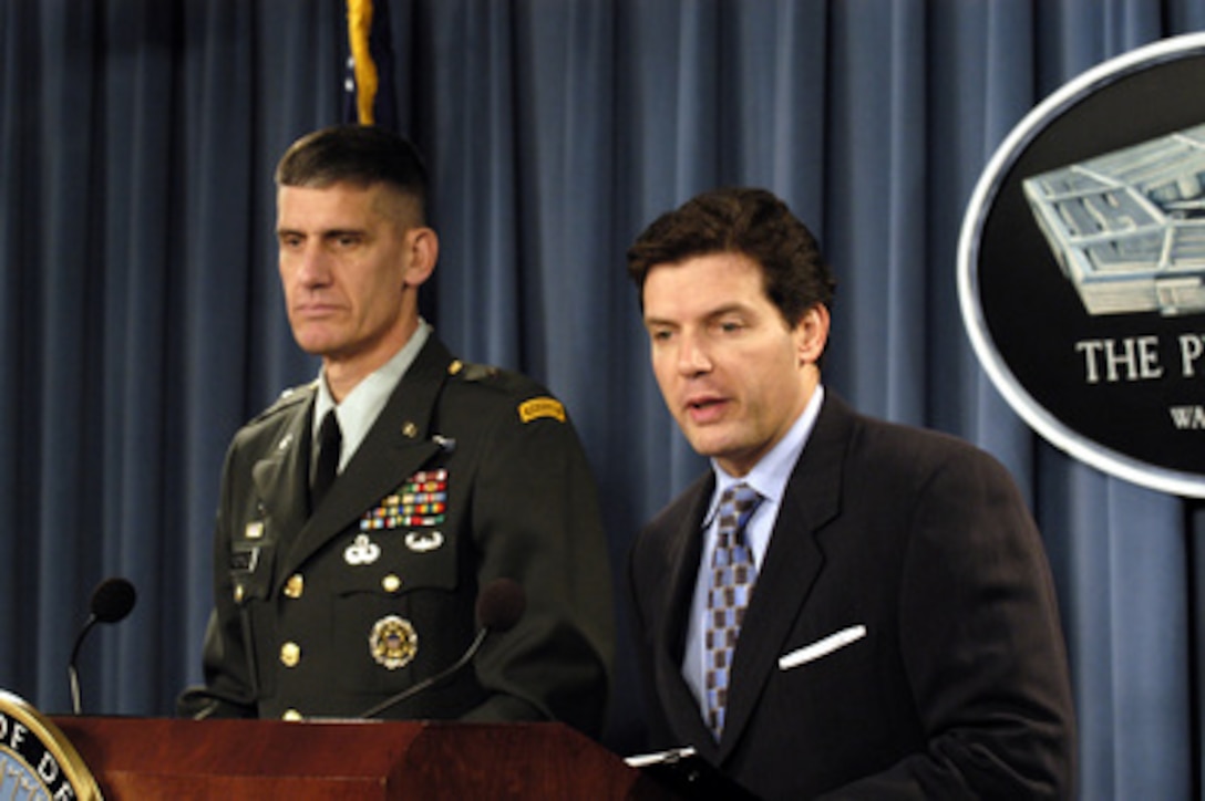 Principal Deputy Assistant Secretary of Defense for Public Affairs Lawrence Di Rita (right) responds to a reporter's question during an operational update briefing in the Pentagon on Dec. 14, 2004. Di Rita and Joint Staff Deputy Director of Operations Brig. Gen. David Rodriguez, U.S. Army, briefed reporters on operations in Iraq and Afghanistan. 