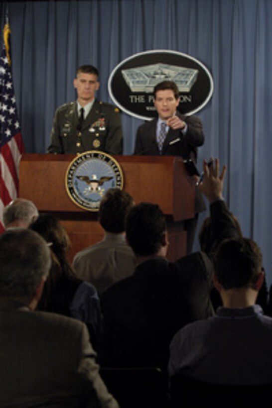 Principal Deputy Assistant Secretary of Defense for Public Affairs Lawrence Di Rita (right) calls on a reporter for a question during an operational update briefing in the Pentagon on Dec. 14, 2004. Di Rita and Joint Staff Deputy Director of Operations Brig. Gen. David Rodriguez, U.S. Army, briefed reporters on operations in Iraq and Afghanistan. 
