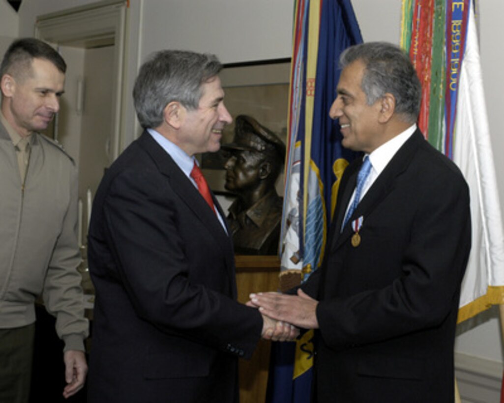 U.S. Ambassador to Afghanistan Zalmay Khalilzad (right) is congratulated by Deputy Secretary of Defense Paul Wolfowitz (center) and Vice Chairman of the Joint Chiefs of Staff Gen. Peter Pace (left), U.S. Marine Corps, after receiving the Department of Defense Distinguished Public Service Award from Secretary of Defense Donald H. Rumsfeld in a ceremony at the Pentagon on Dec. 14, 2004. 
