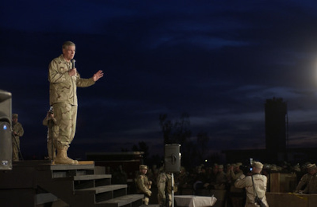 Chairman of the Joint Chiefs of Staff Gen. Richard B. Myers, U.S. Air Force, talks to an audience of U.S. service men and women during a United Services Organization show at Balad, Iraq, on Dec. 14, 2004. Myers, Blake Clark, John Elway, Leann Tweeden and Robin Williams are on a USO tour to meet, entertain and thank the deployed troops. 