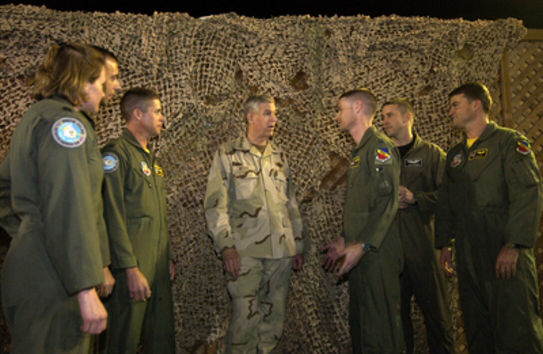 Chairman of the Joint Chiefs of Staff Gen. Richard B. Myers (center), U.S. Air Force, talks with U.S. Air Force pilots from the 380th Air Expeditionary Wing during a United Services Organization show in Southwest Asia on Dec. 15, 2004. Myers brought a United Services Organization show featuring Blake Clark, John Elway, Leann Tweeden and Robin Williams to the Truman to meet, entertain and thank the deployed airmen. 