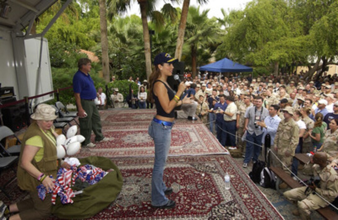 Model and sports show host Leann Tweeden (right) introduces actor/comedian Blake Clark (left) to a audience of U.S. sailors and Marines during a United Services Organization show at the 5th Fleet Headquarters in Manama, Bahrain, on Dec. 15, 2004. Tweeden and Clark joined Chairman of the Joint Chiefs of Staff Gen. Richard B. Myers, U.S. Air Force, John Elway, and Robin Williams on the USO tour to meet, entertain and thank the deployed sailors and Marines. 