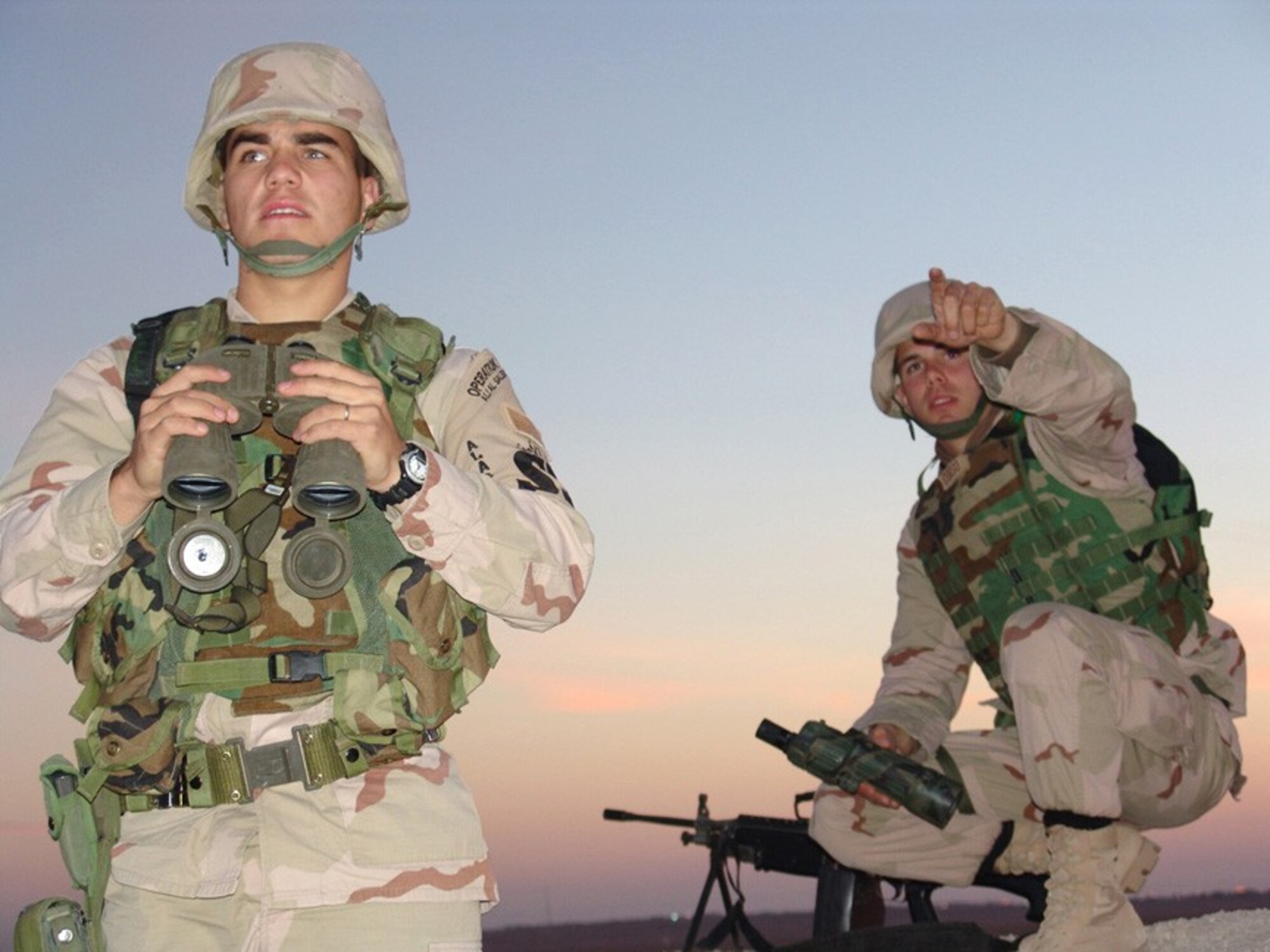 SOUTHWEST ASIA (AFPN) -- Senior Airman David Jensen (left) and Airman 1st Class Brian Corso, both of the 386th Expeditionary Security Forces Squadron Viper Flight, observe the surrounding area to ensure there are no threats to aircraft landing and taking off here.  The 386th ESFS is responsible for defending the base from attack.  (U.S. Air Force photo by Senior Airman Nicole Spence)
