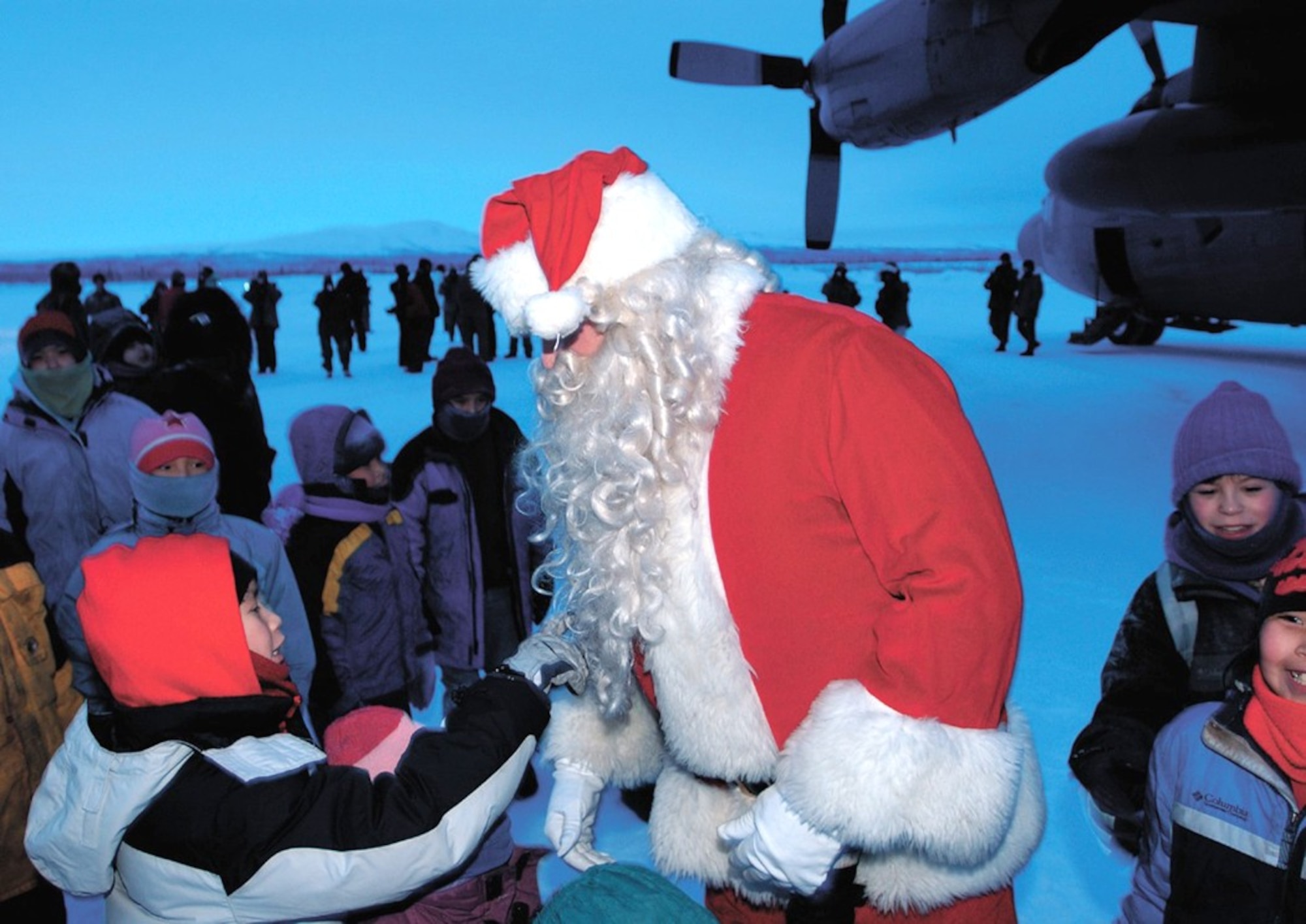 ARCTIC VILLAGE, Alaska -- Children here greet Santa Claus recently. The Alaska-native community is north of the Arctic Circle where Santa delivered gifts and supplies for the 37th year in a row.  Santa traveled to the village on a C-130 Hercules from Elmendorf Air Force Base's 517th Airlift Squadron. (U.S. Air Force photo by Tech. Sgt. Keith Brown)