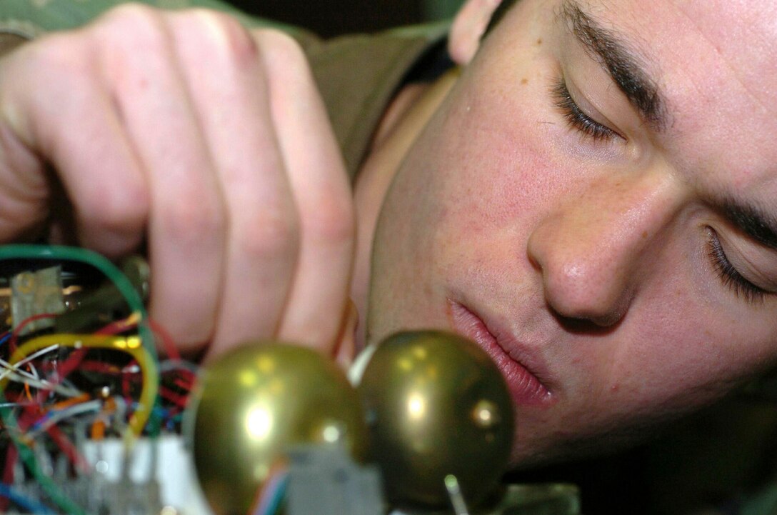 GWANGJU AIR BASE, South Korea -- Senior Airman Arthur E. Lewis repairs the ringer on a standard 2500 model phone that here Dec. 9.  He is part of the 3rd Air Expeditionary Group. Airman Lewis is deployed from the 354th Communications Squadron at Eielson Air Force Base, Alaska (U.S. Air Force photo by Senior Airman Chris Willis)